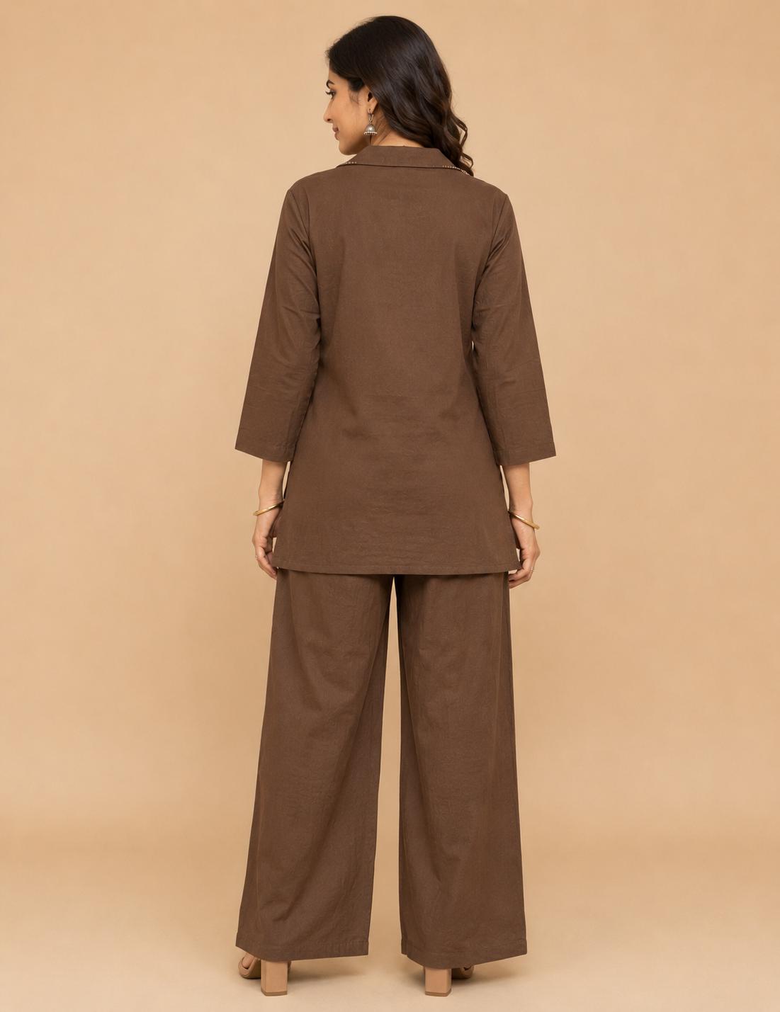 May include: A solid brown two-piece set consisting of a long-sleeved tunic with a collared neckline and matching wide-leg trousers. The tunic features three-quarter length sleeves and a straight hemline, while the trousers have a loose fit.